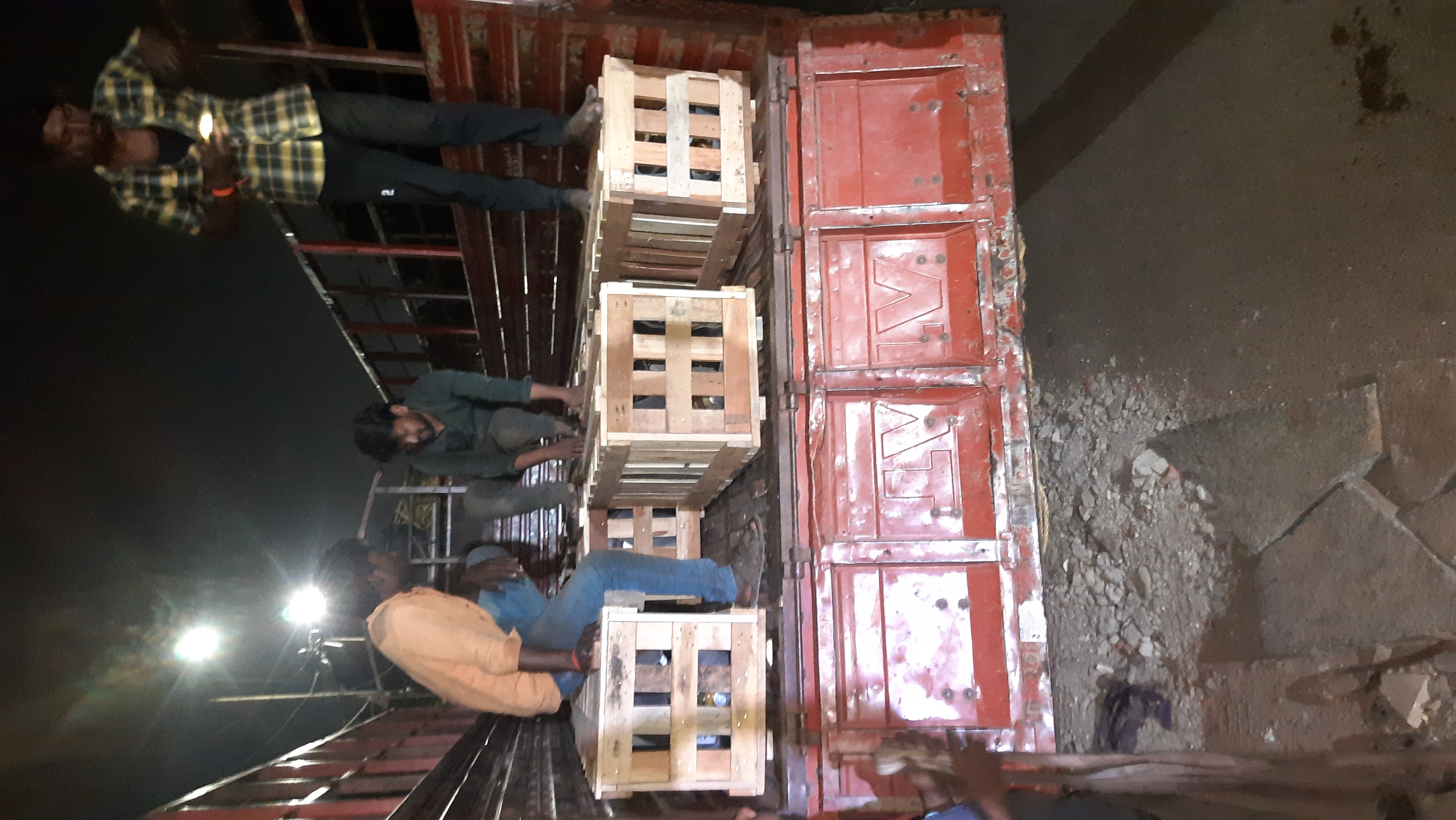 Crates being loaded for dispatch at night